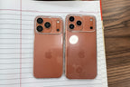 Two rose gold iPhones on a white surface