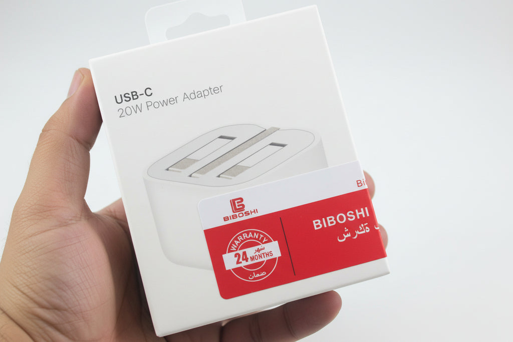 USB-C power adapter packaging with BIBOSHI branding held by a hand.